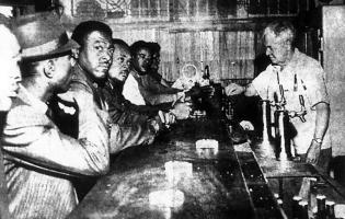 4 men being served in a bar
