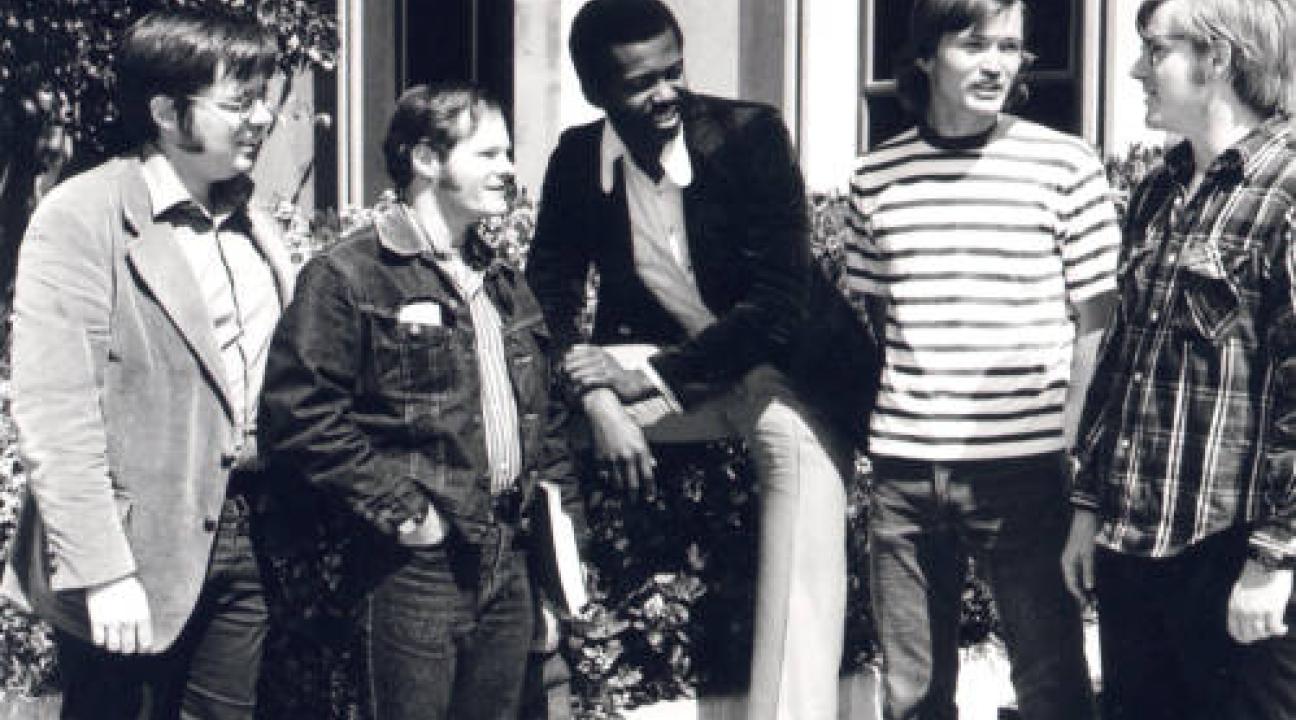 5 men in conversation