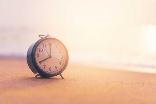 Wind up clock on the beach