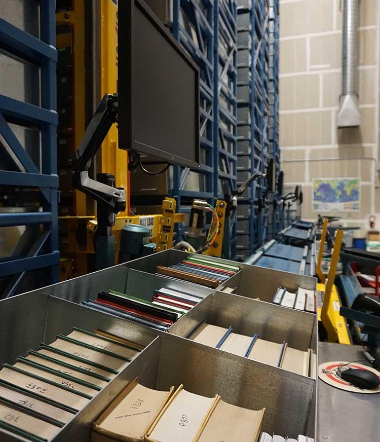 Books in the bins of the Automative Retrieval System.