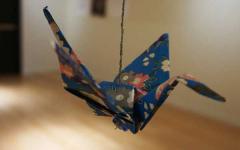 Origami bird suspended from a line.