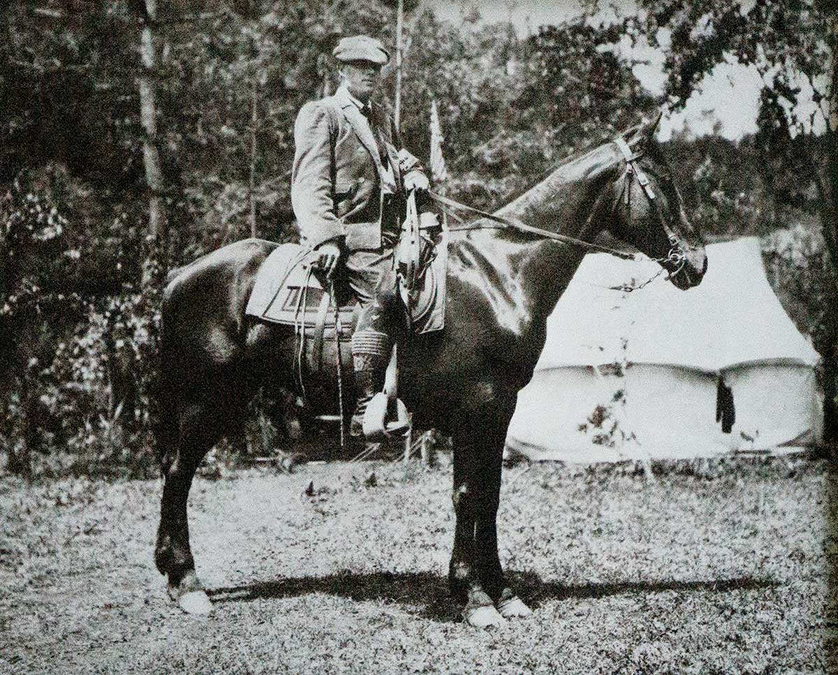 A man rides a horse. They are facing the right.