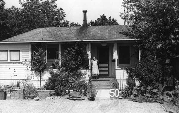 Woman standing in front of a house.