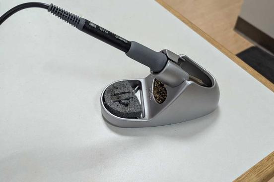 Sodering tool, grey with a black extension cord.