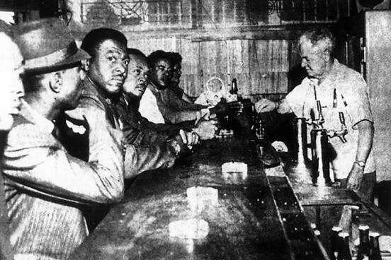 4 men being served in a bar