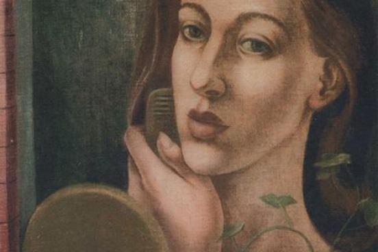 Woman combing her hair, looking into a mirror.