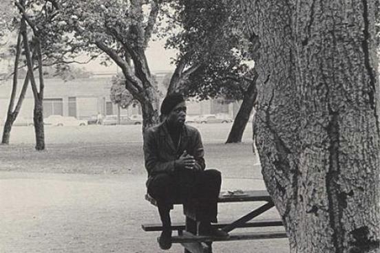 A man sits on a picnic table.