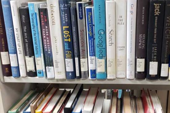 Row of library books on a shelf