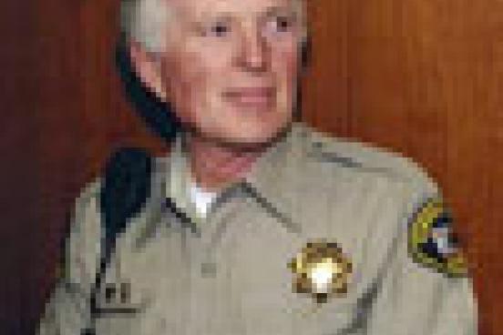 Man wearing a sheriff outfit.