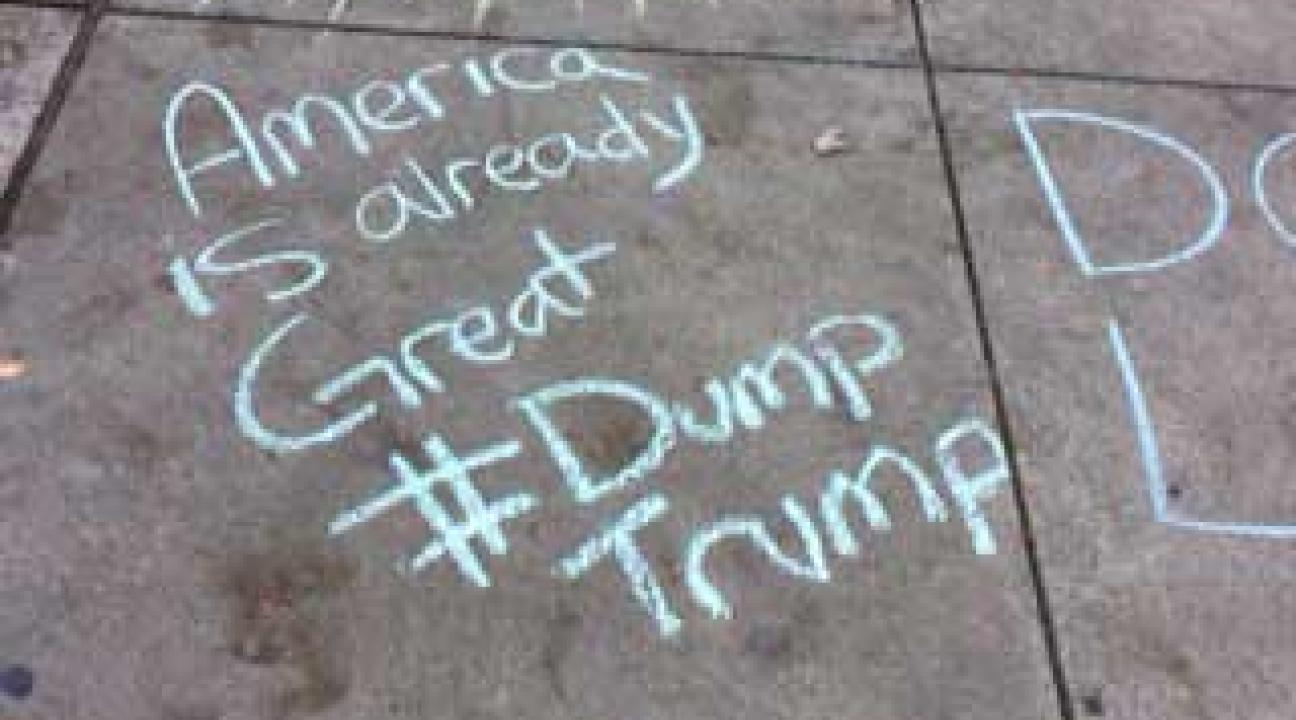 Chalk text of "America is already great #Dump Trump"