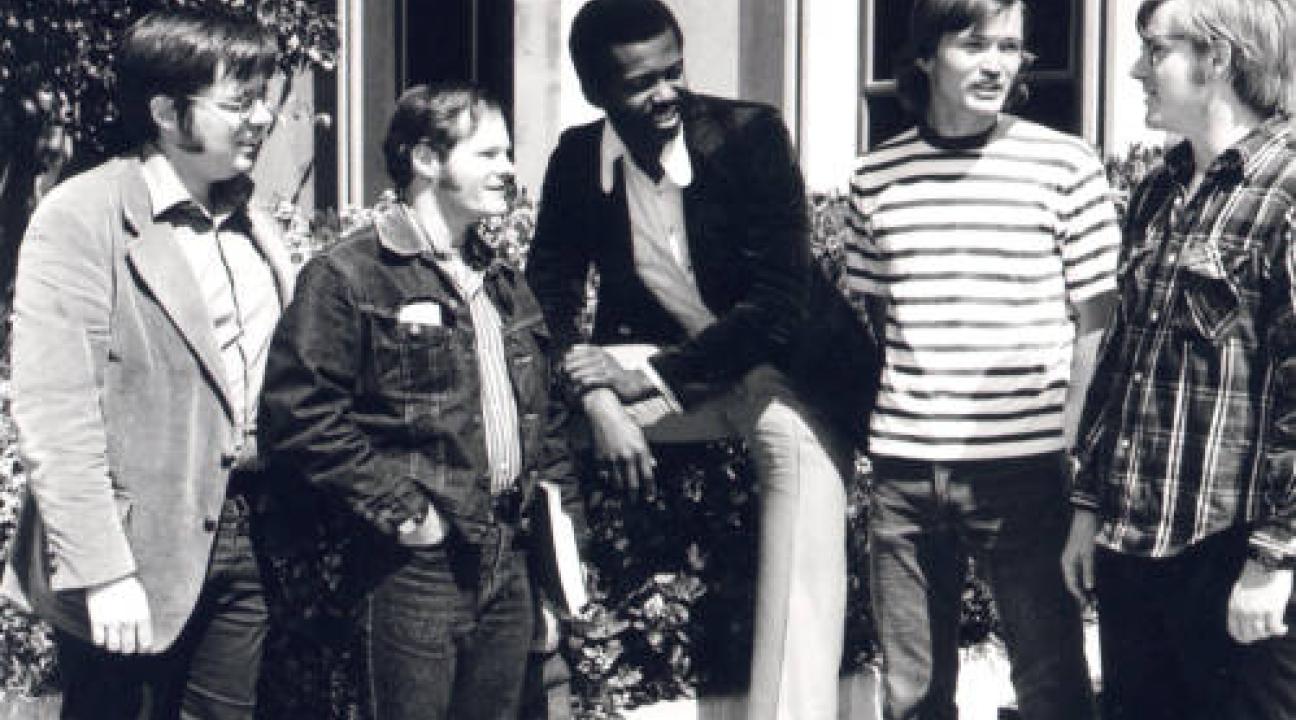 5 men in conversation