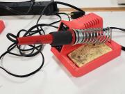 Tool with a red base, and electric cord.