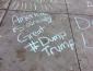 Chalk text of "America is already great #Dump Trump"