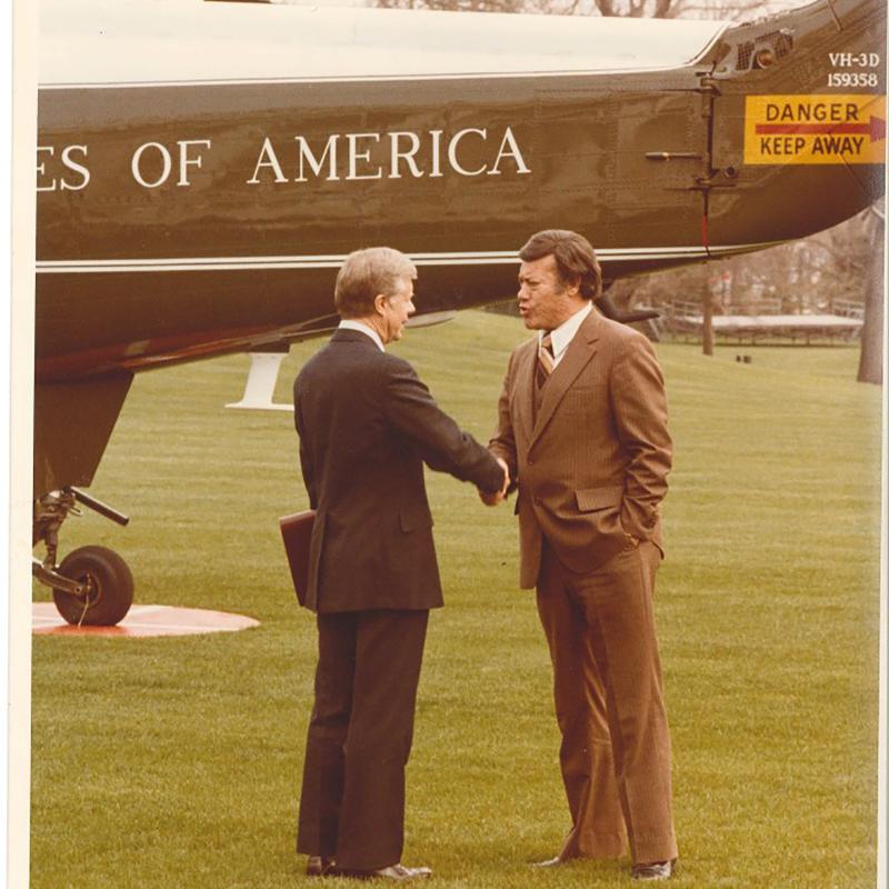 Photograph of President Carter and Ambassador Esteban Torres on the White House lawn