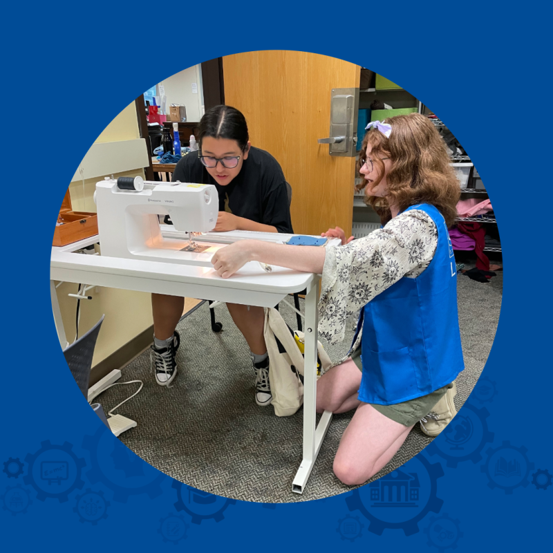 Image of two people sewing together in the Makerspace