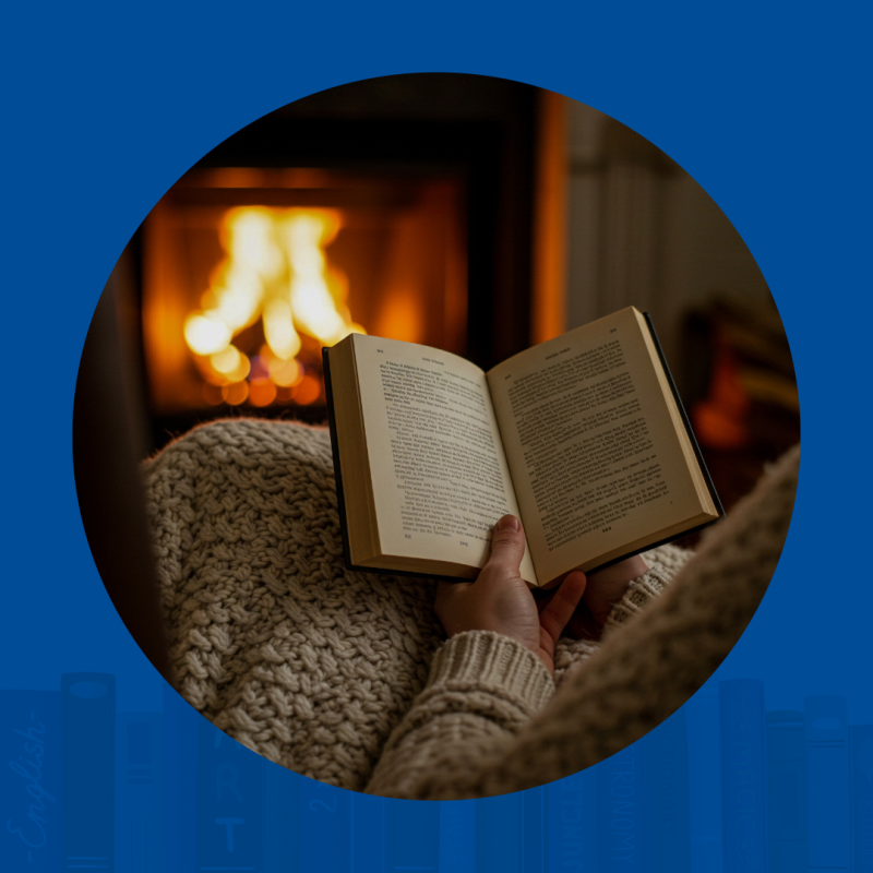 Open book is being held and read in front of a fire