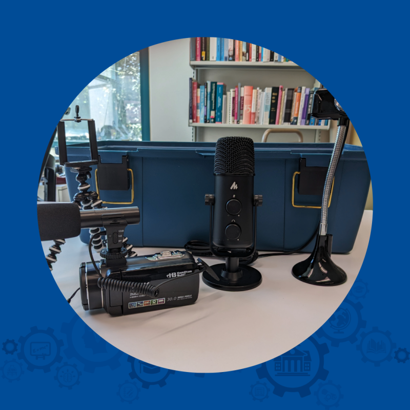 Microphone, camera and other media items in front of a carrying case.