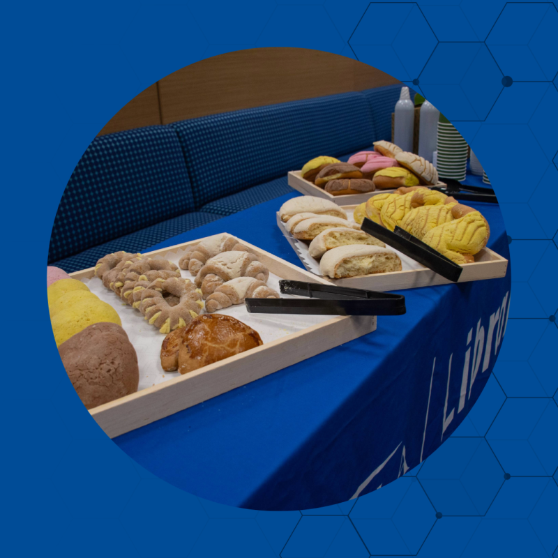 Pastries on 2 wooden trays, two tongs are next to the trays.