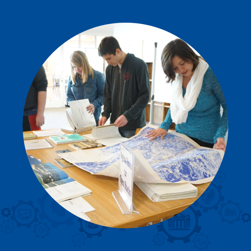 People looking at research material