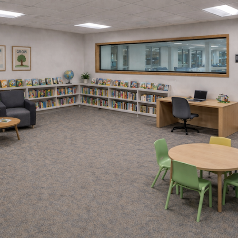 Rendering of a possible family study room with soft seating, a desk, children's books, and a child-sized table and chairs