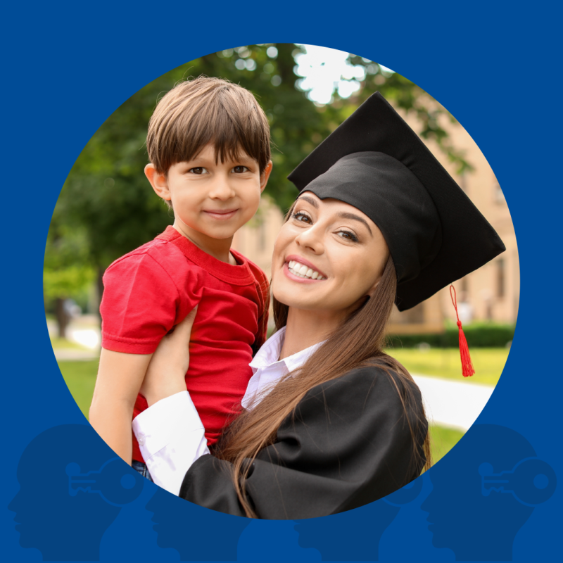 A photograph of a young woman wearing graduation regalia and holding a small boy. Both are smiling. 