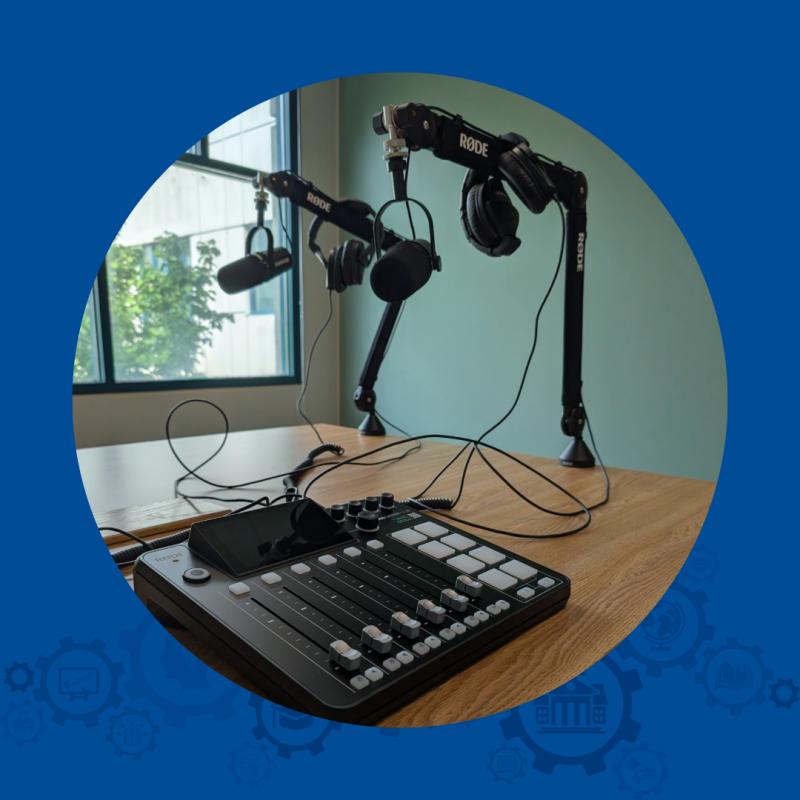 Photo of an audio mixing board and two mounted microphones for audio recording