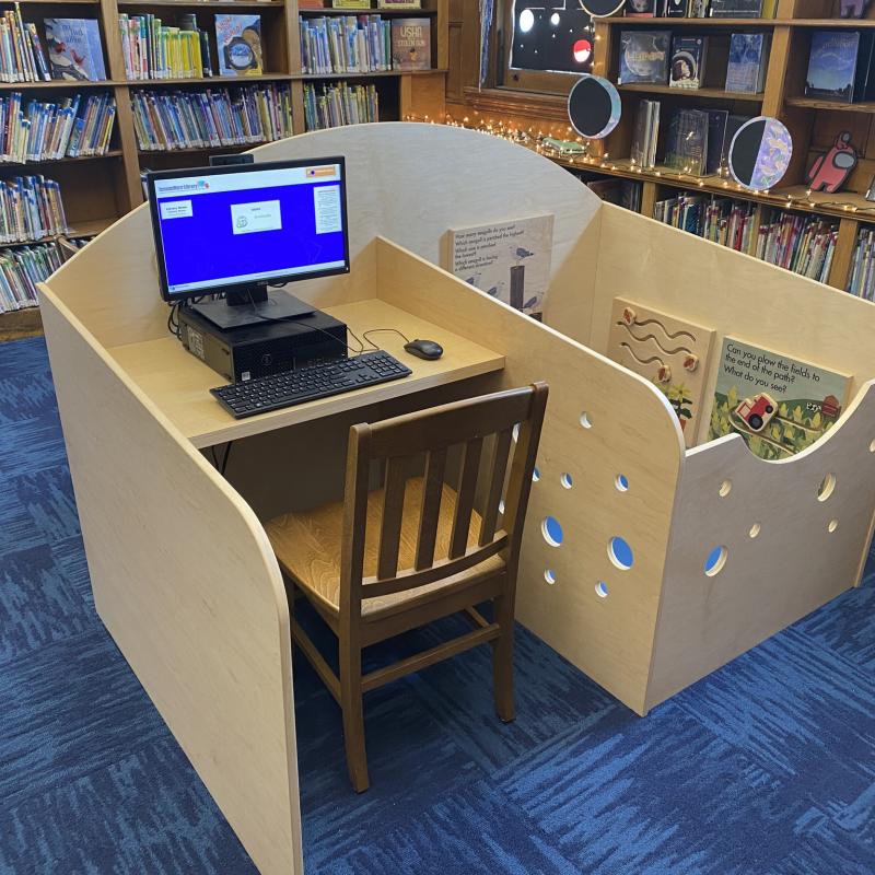 An image of a Family Workstation, a desk with an attached enclosed play area for young children