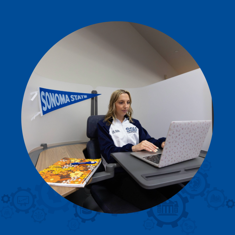 Woman studying with a book and laptop.