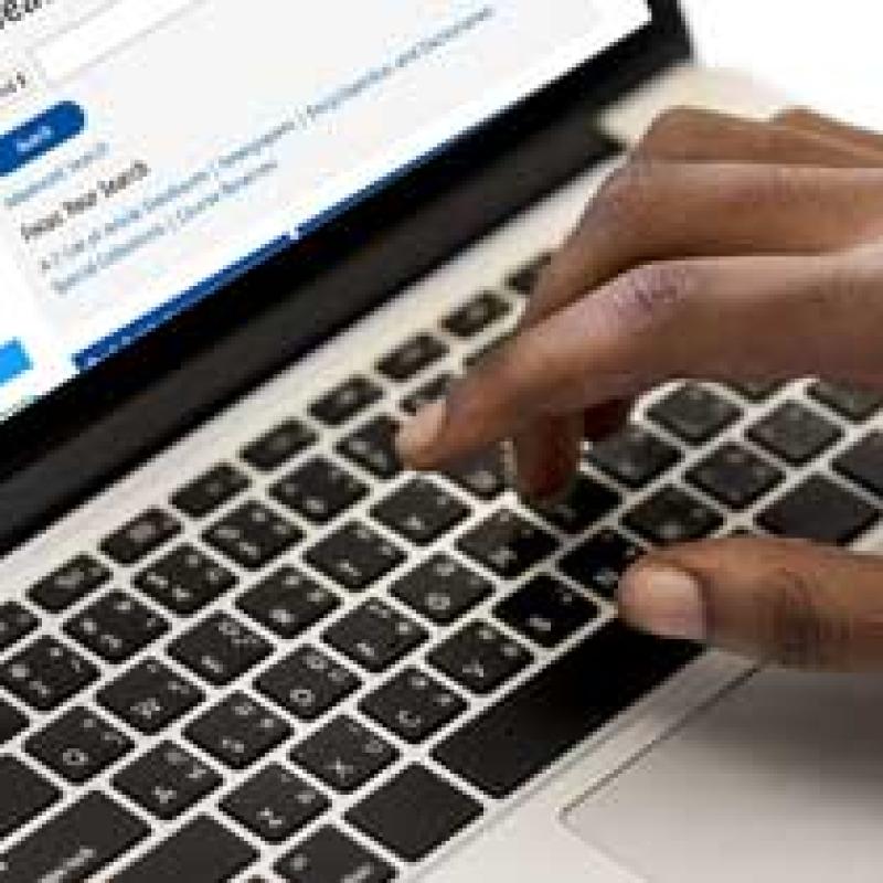 Closeup of a hand typing on a keyboard