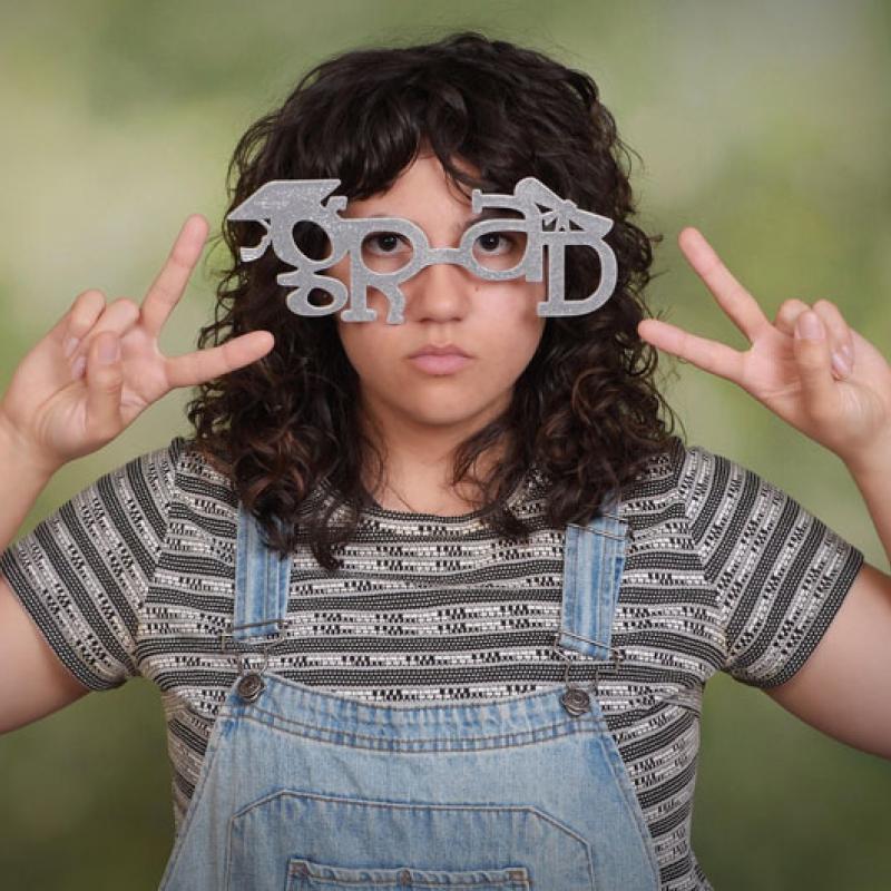 Woman with glasses that spell Grad