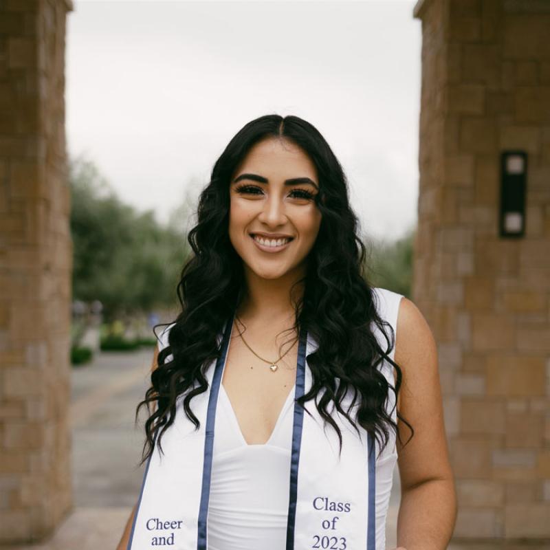 Woman wearing a graduate stole.