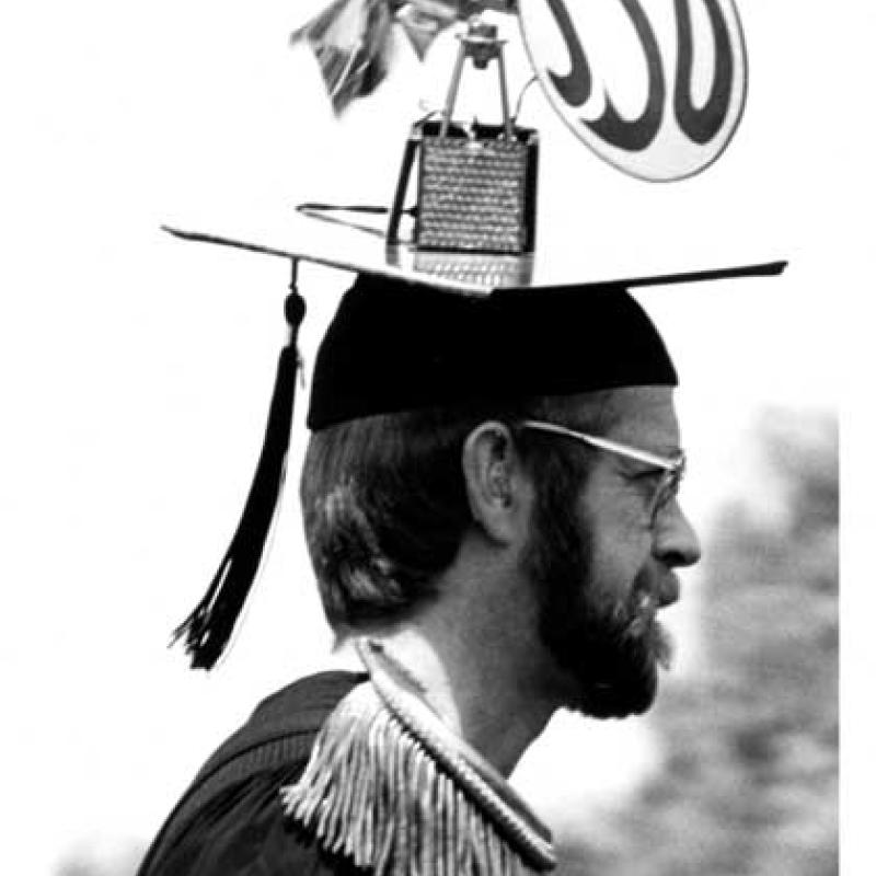 Mn wearing a mortarboard, small windmill with SSU label