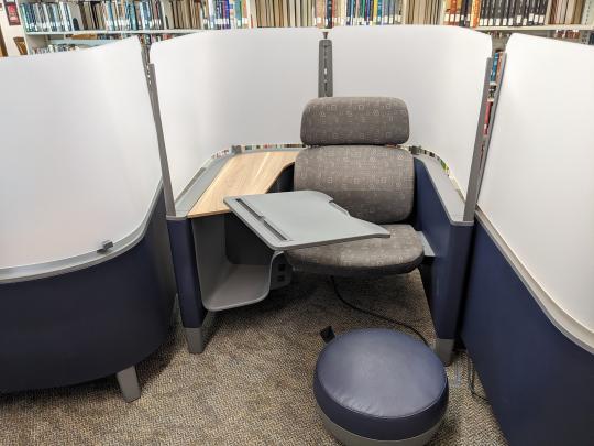 Photo of a study carrel with a movable desk and footrest