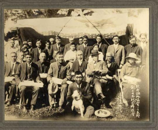 3 rows of people pose for a photograph