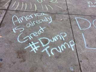 Chalk text of "America is already great #Dump Trump"