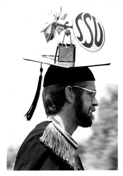 Mn wearing a mortarboard, small windmill with SSU label