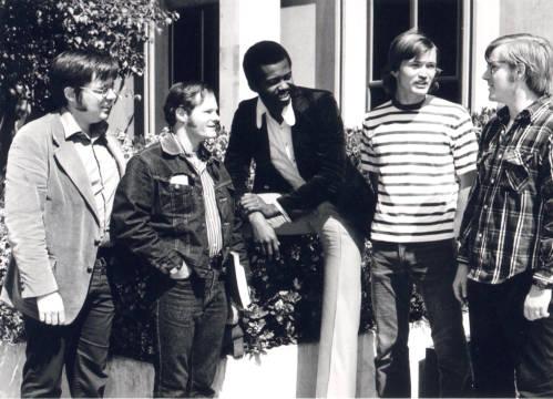 5 men in conversation