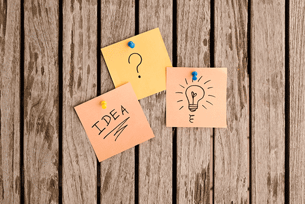3 post in notes on a wood background. Note 1 is a question mark. Note 2 is a lightbulb Note 3 is the word Idea
